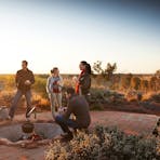 Watch the amazing transformation of colours and life as the desert awakens with Uluru as the backgro