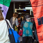 Festival-goers enter a screening at MASIFF, passing banners welcoming them to a celebration of film