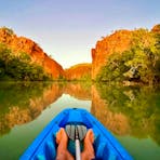 Man canoeing in gorge.