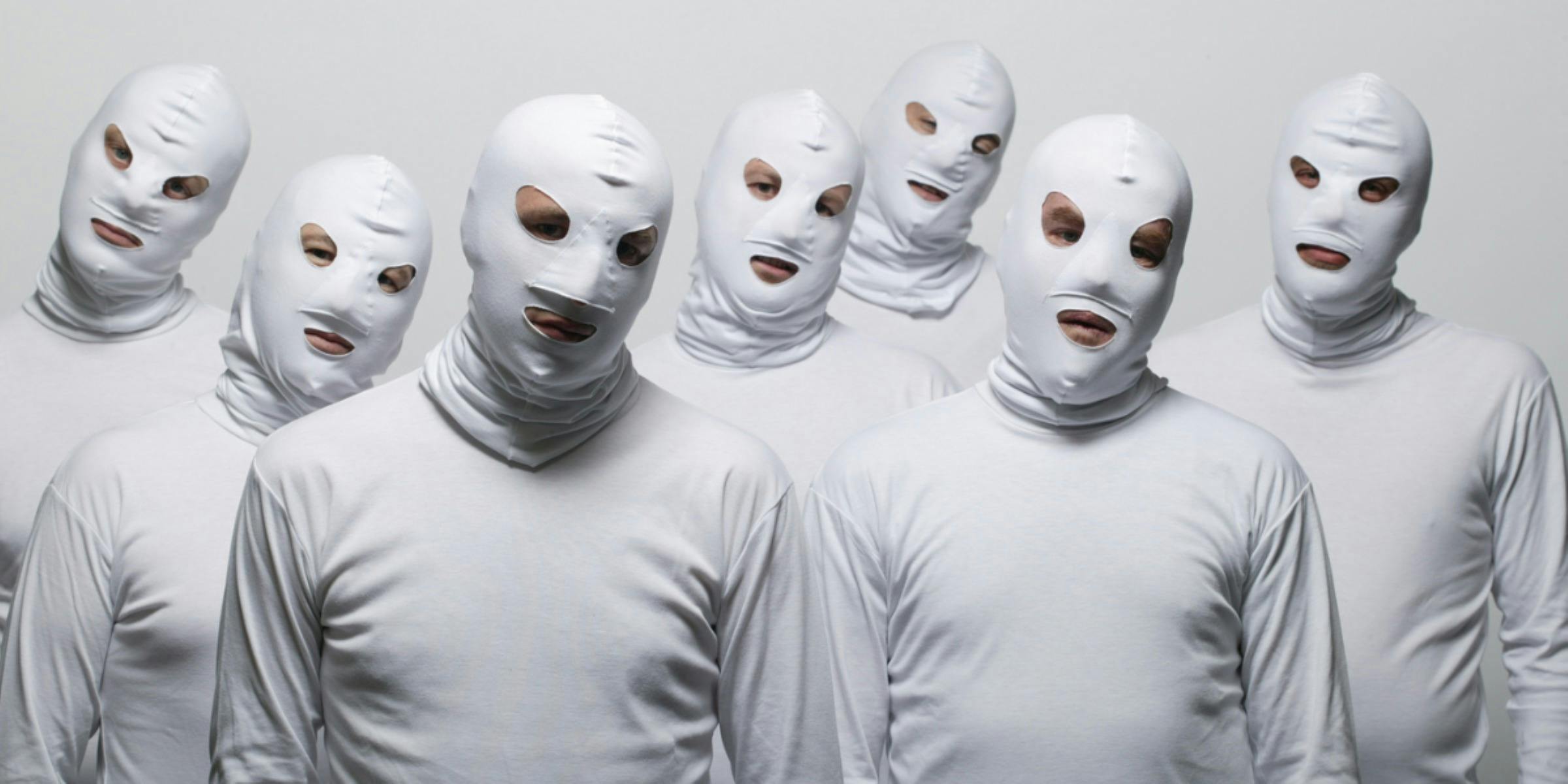 Band members dressed in white costumes