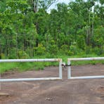 Entrance track leading to the airfield that is closed and signs warn not to enter.