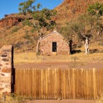 A historic building and gate at Barrow Creek Telegraph Station