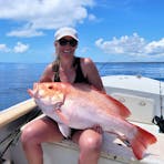 A glassed of morning and a female client holding the biggest Nannagai that most locals had ever seen