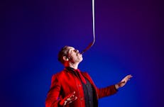 Comedian balancing a bat on his mouth