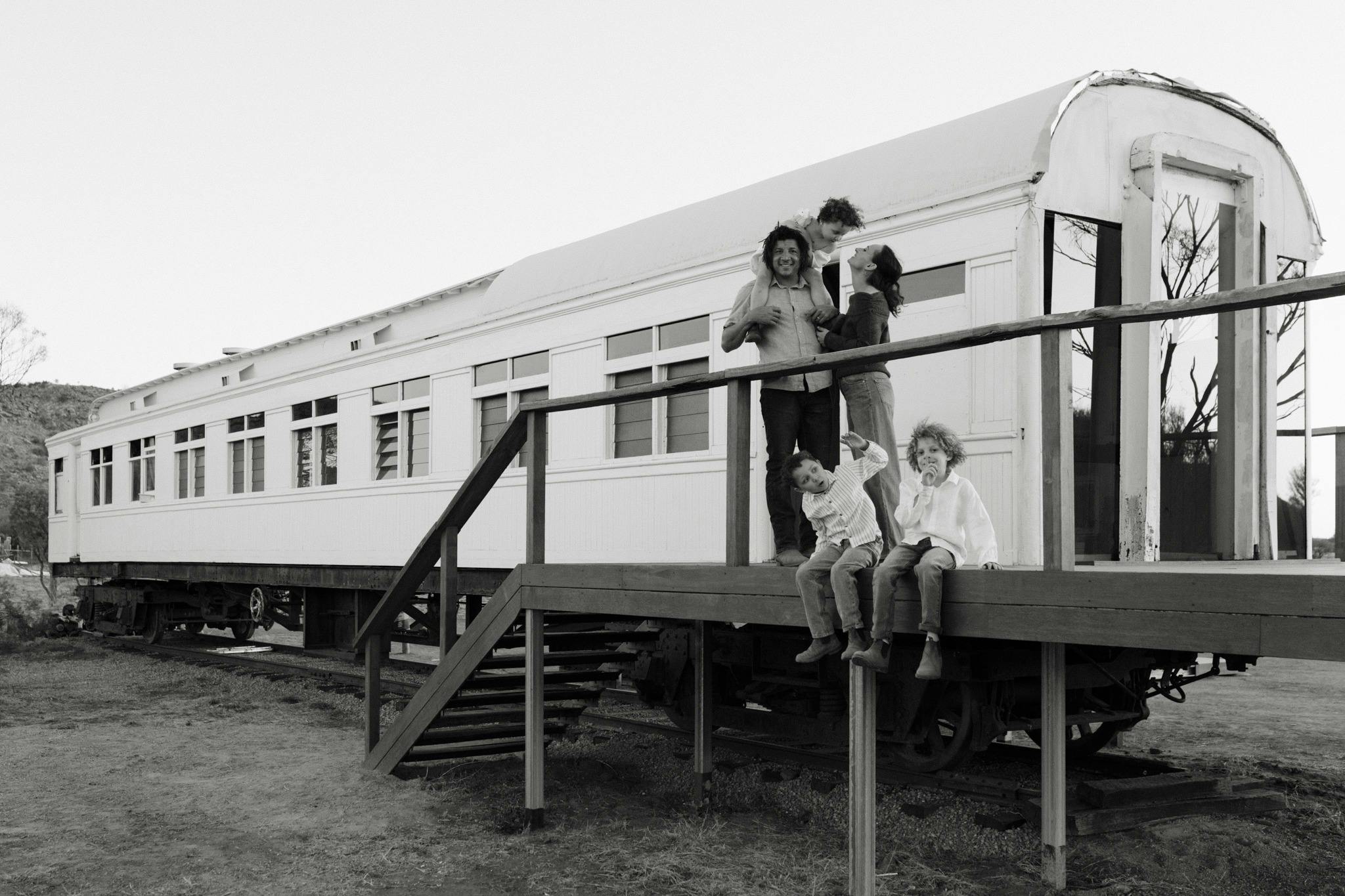 Family standing in front of train carriage