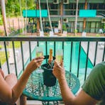 Couple enjoying a glass of Champagne on the balcony at Litchfield Outback Resort