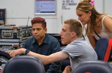A young man learning about Audio Visual at an Expo