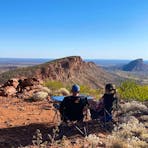 Couple enjoying the views and serenity after landing on top of the East MacDonnell Ranges