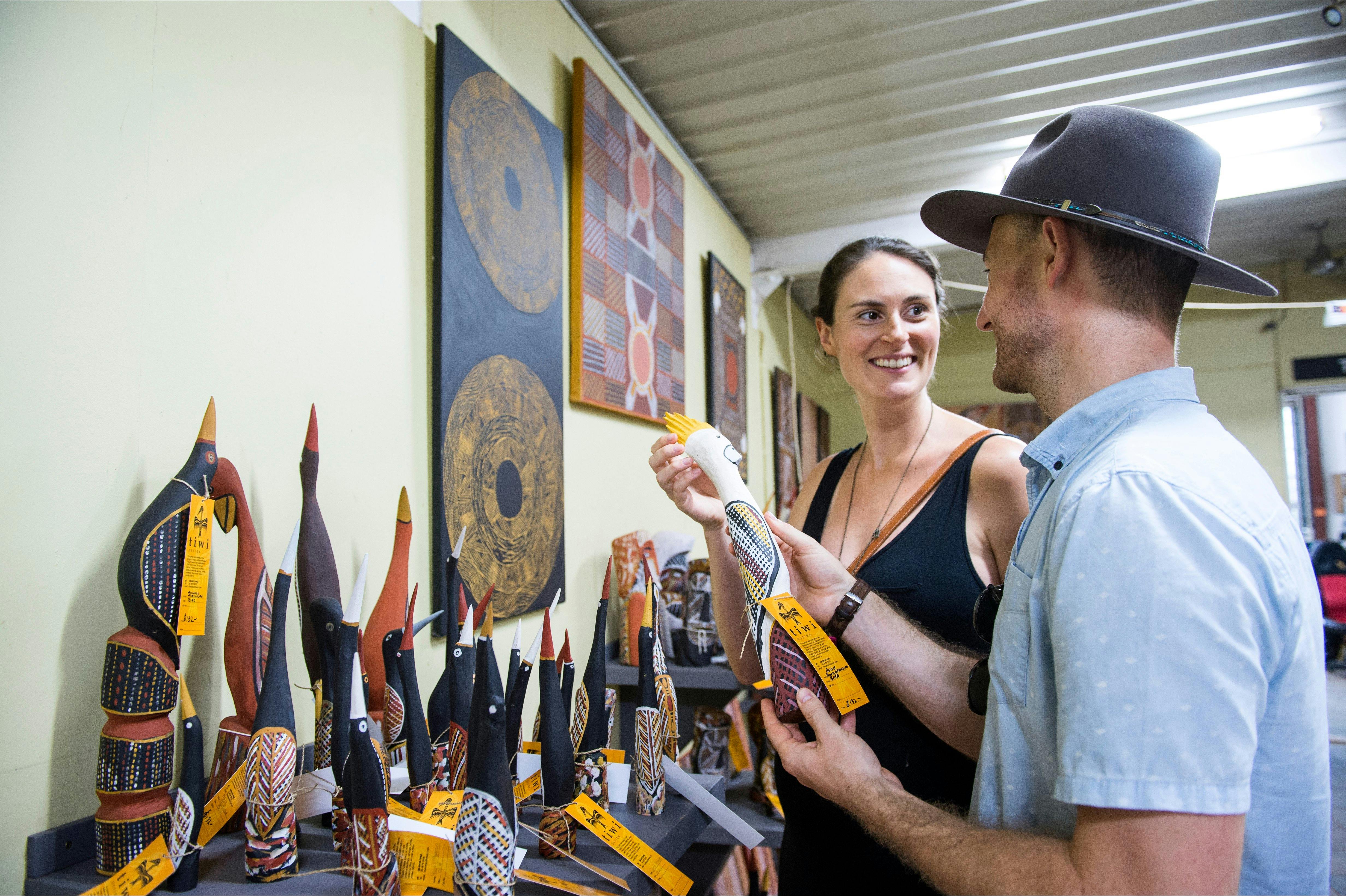 A couple admiring Tiwi art pieces