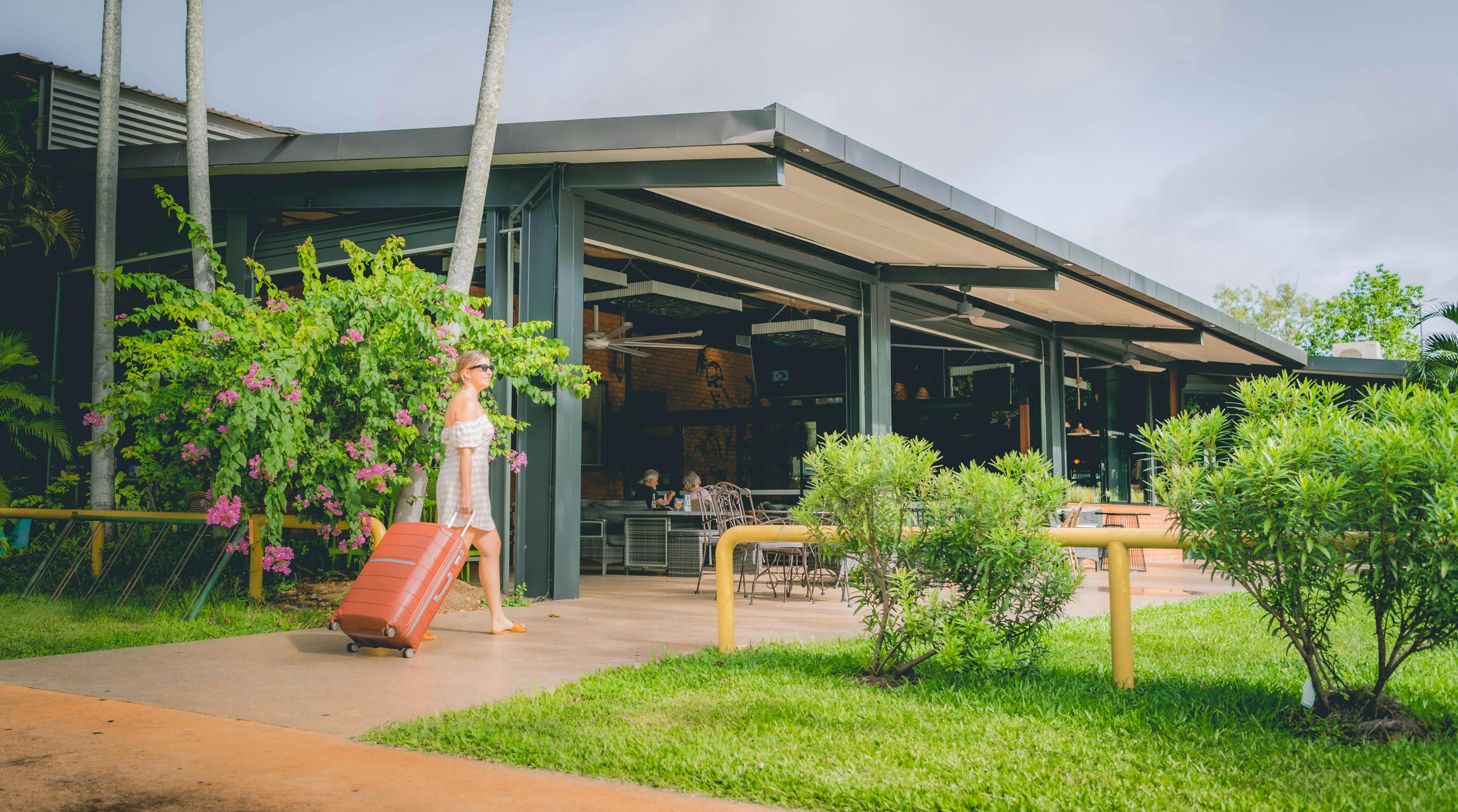 Woman with suitcase checking in at Litchfield outback resort