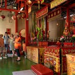A group of people stand near the alter in Darwin Chinese Temple