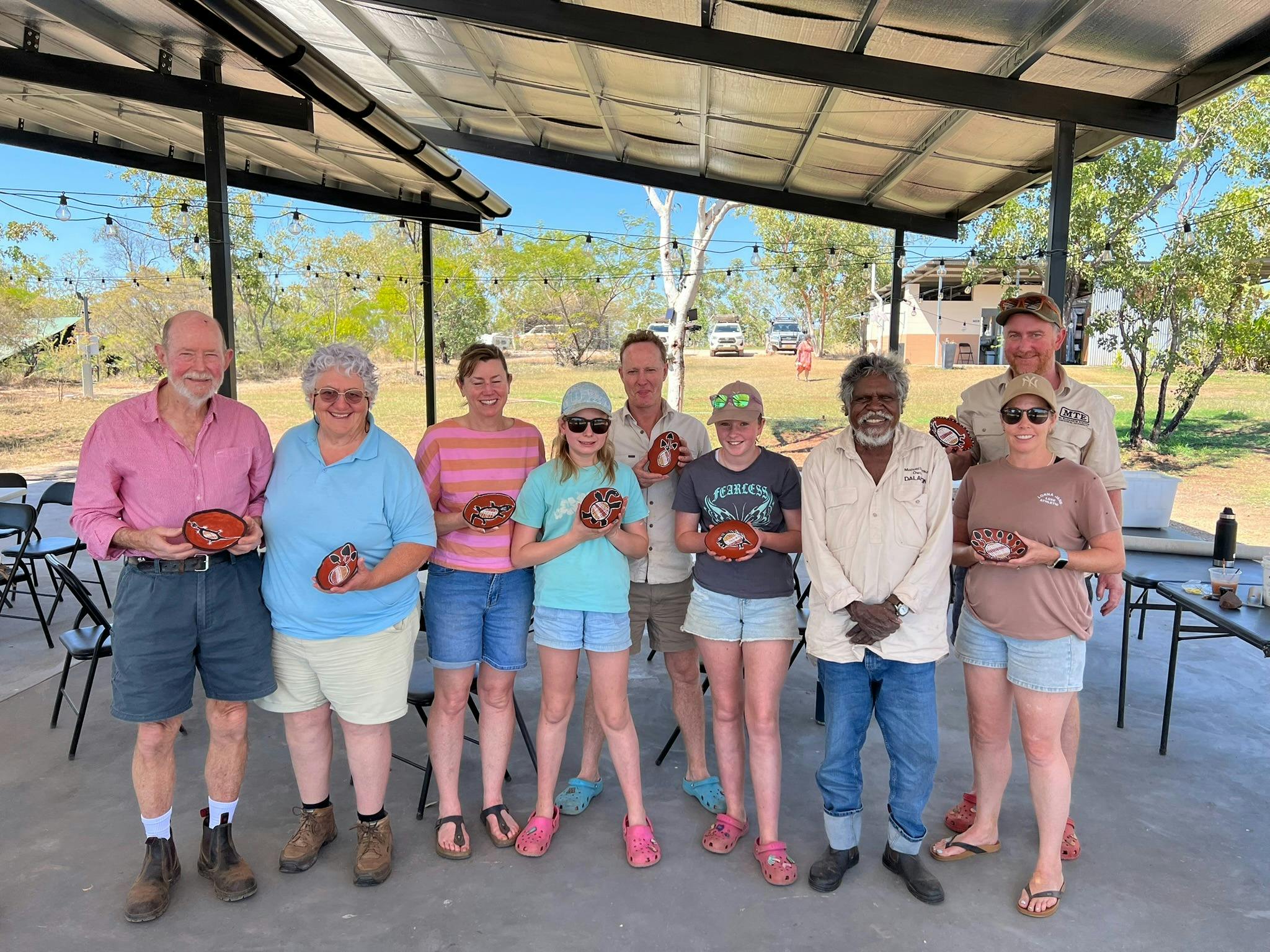 a group hold small artworks