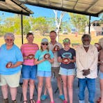 a group hold small artworks