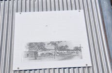 Faded and illegible interpretative panel at the site.