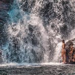 Girl at the bottom of a waterfall in Litchfield National Park