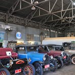 Interior of the Hangar showing the roof trusses and framing. The display is by the Automobile Enthusiasts Club.