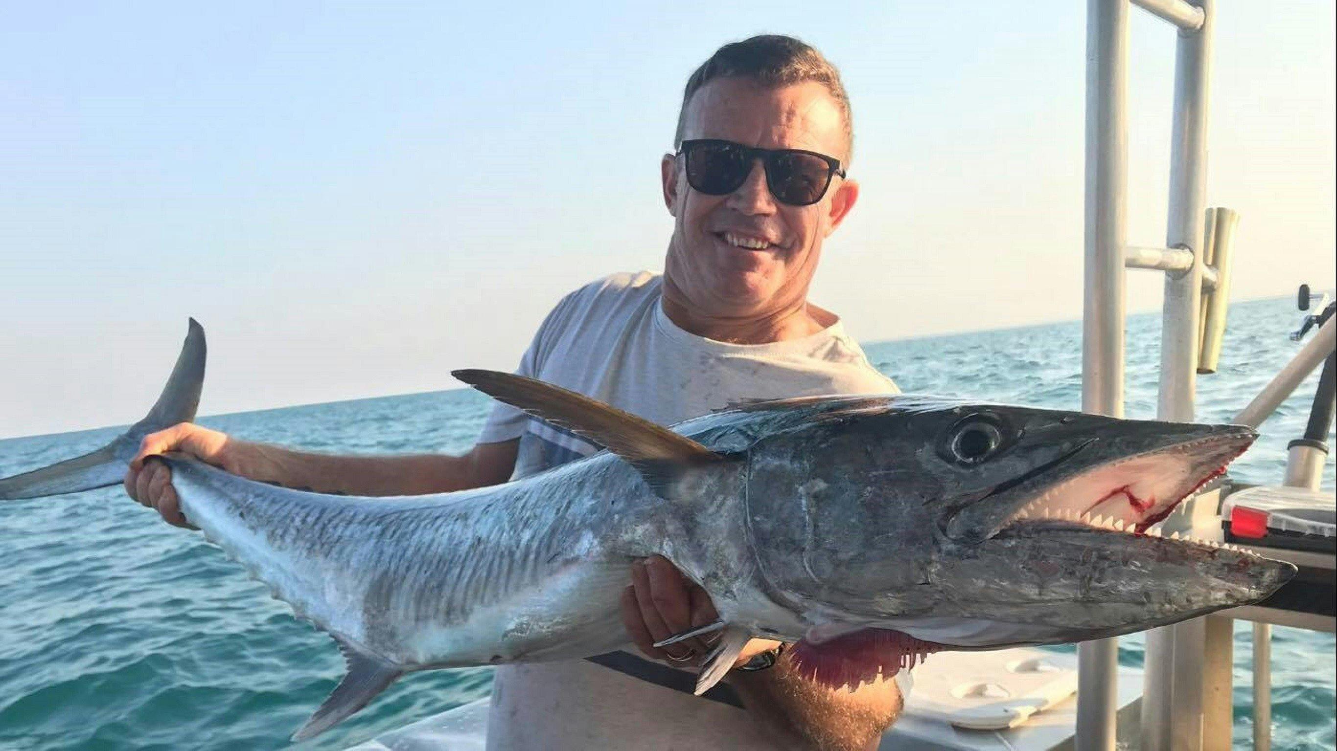A man holding a Spanish Mackerel at Offshore Boats
