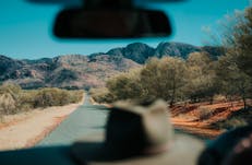 Hat on the dashboard of a car driving through the Red Centre