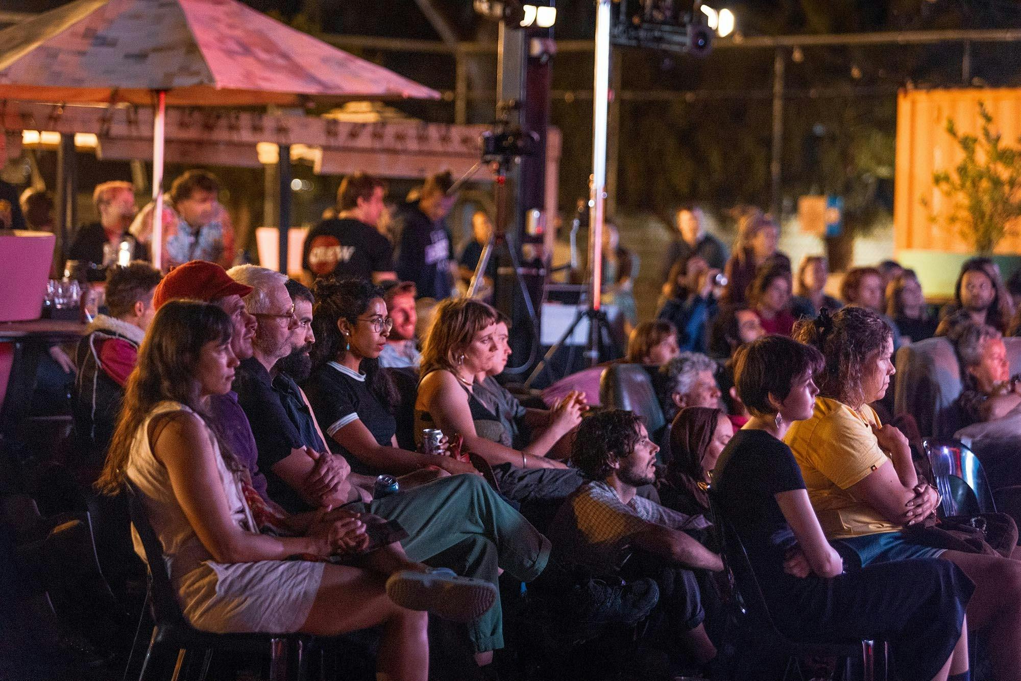 Audience seated at night time listening intently