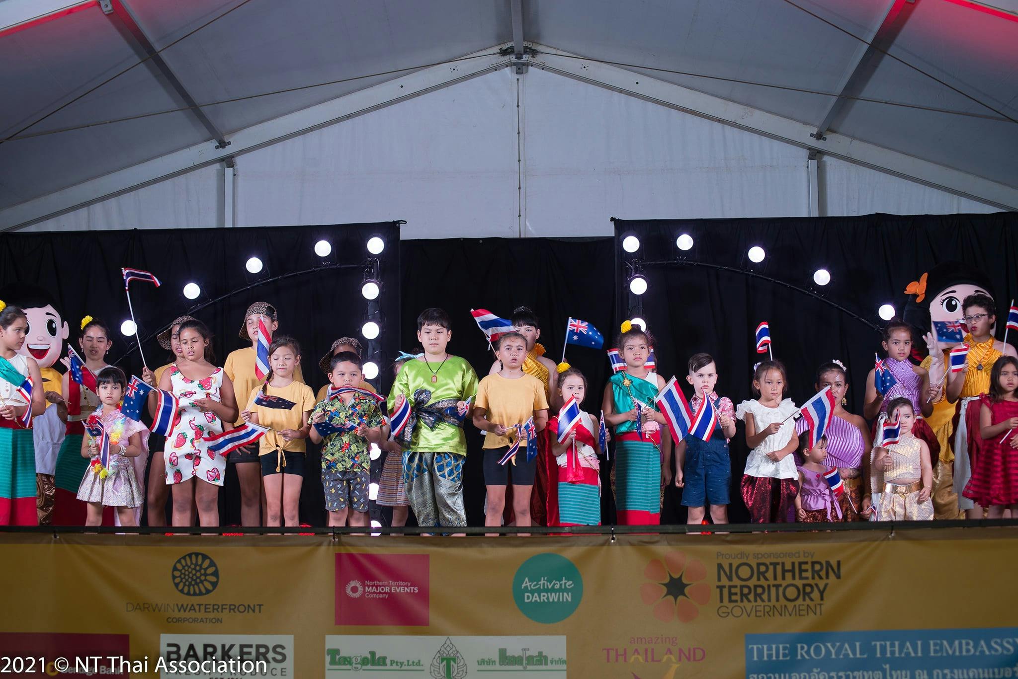 Children stand up for the Thai National Anthem