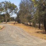 Gravel road leading into Wanggardi Caravan Park near Alice Springs