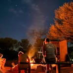 Guests enjoying the starry night at the campsite