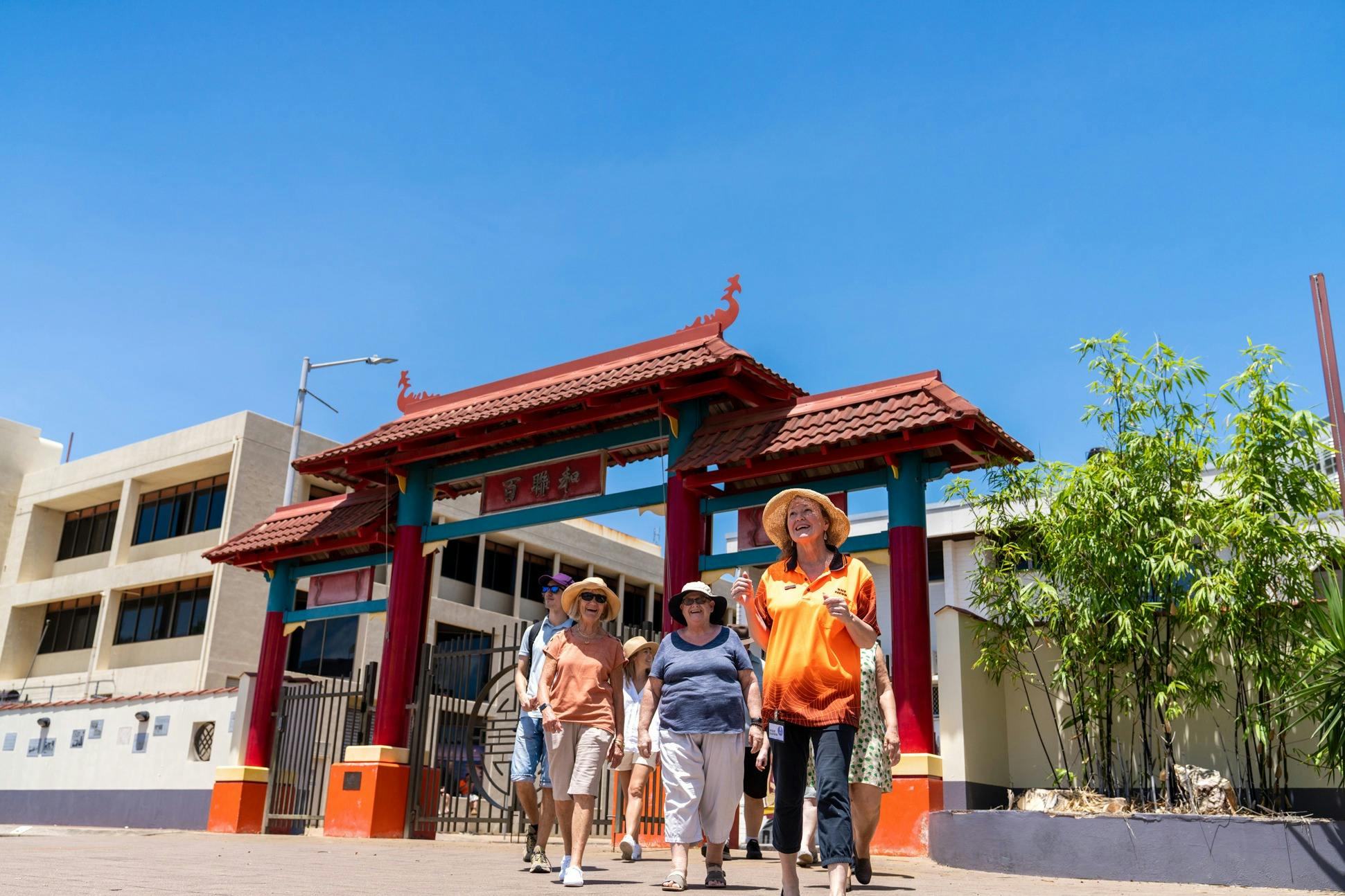 Walk Darwin guide leads group through Chinese-styled gates