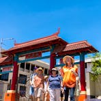 Walk Darwin guide leads group through Chinese-styled gates