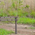 walking track with sign pointing to the World War Two bunker being 100m away