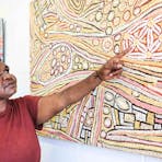 Artist Esther Bruno Nangala explaining her Bush Raisin Dreaming painting.