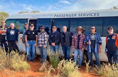 men standing by a bus