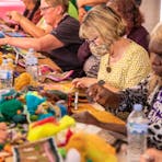 Indigenous artists from remote communities travel to Alice to teach the public how to make beanies.