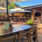 Shaded outdoor seating at the Lazy Lizard Tavern