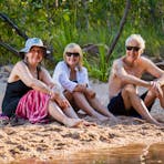 Trekkers relaxing by a waterhole on the Kakadu Walking Adventure