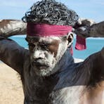 Aboriginal man tying on a bandana in East Arnhem Land