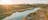 Aerial view of campers on the waters edge at Finke River 2 Mile at sunset