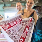 Tourists admiring Tiwi art with a local artist