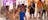 gallery with soft sculptures, aboriginal paintings in background and people looking at them