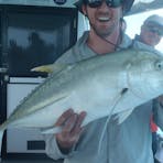 Guy catches a Queenfish on a Bluewater fishing charter