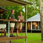 Two people drinking coffee on the balcony of their habitat villa at Seven Spirit Bay