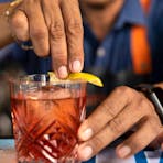 A staff member making a cocktail at the Sandbar in Mindil Beach Casino Resort