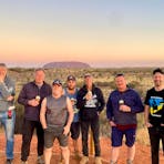 CUstomers enjoying a drink as the sun sets over Uluru