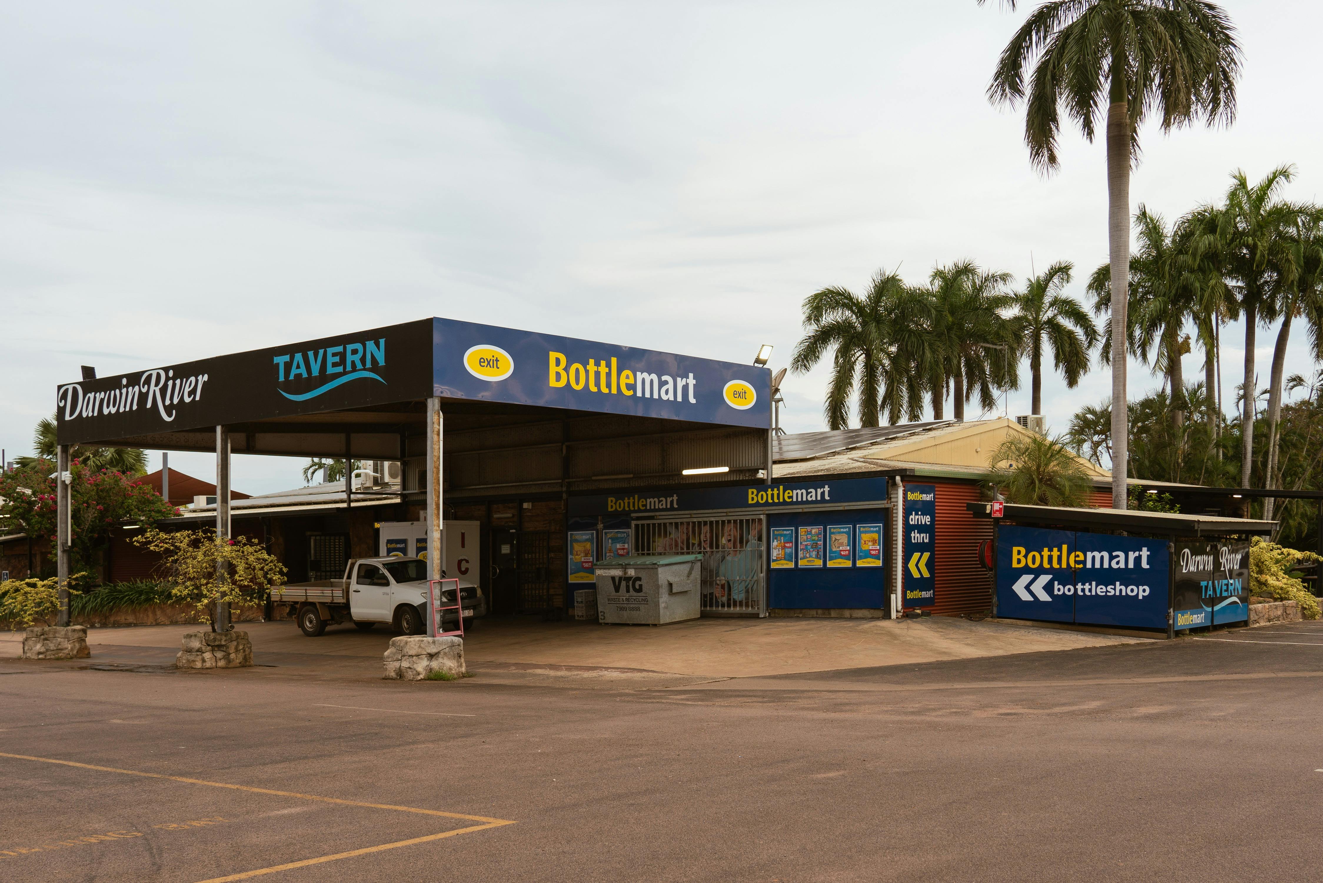 Front entrance of Darwin River Tavern with bottle shop and tropical surroundings