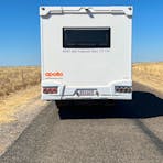 A 6 berth motorhome driving through the outback
