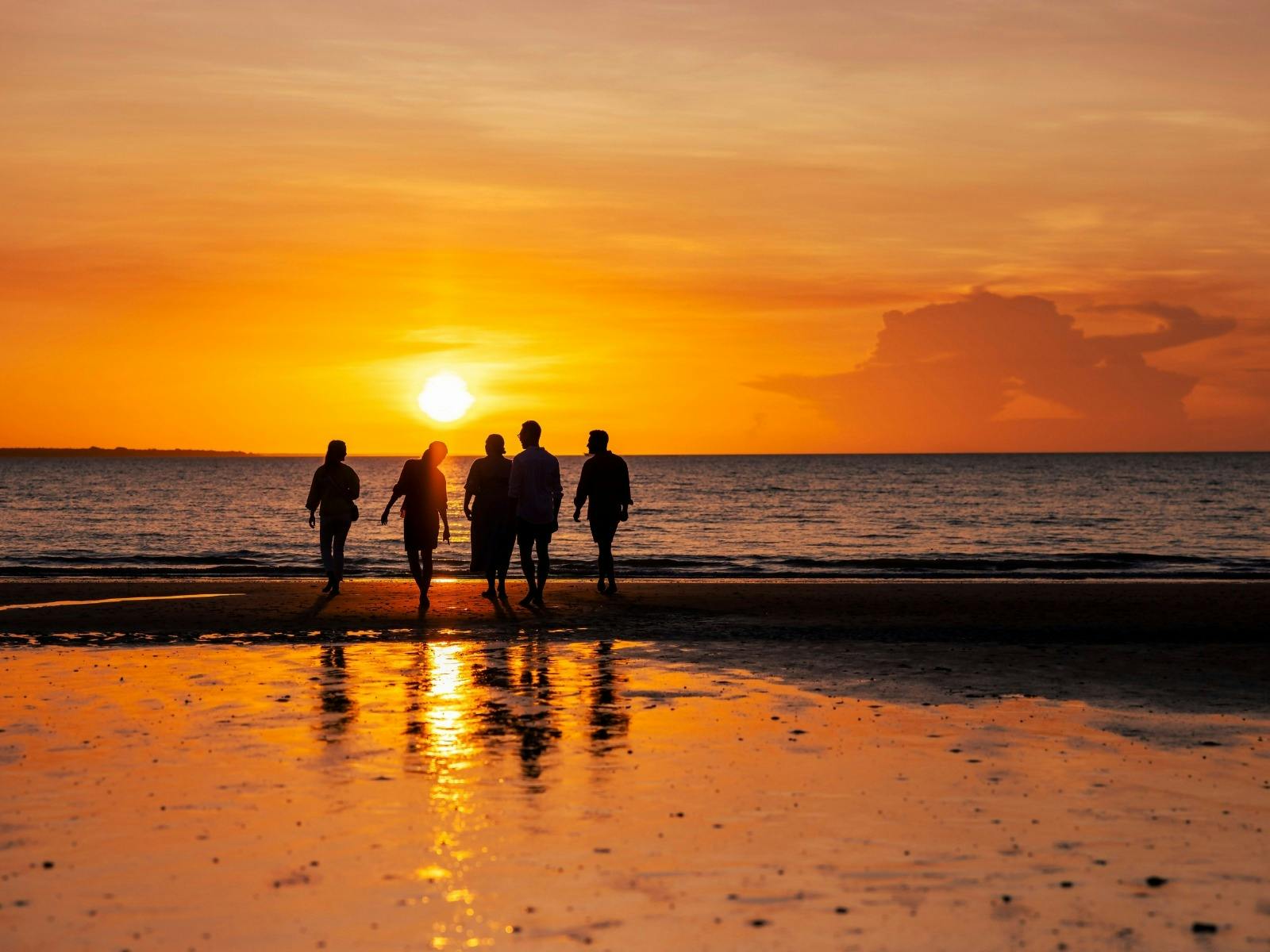 Family enjoying a peaceful sunset together at the beach