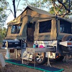 Camper trailer set up at campsite at Samson Creek Nature Park.