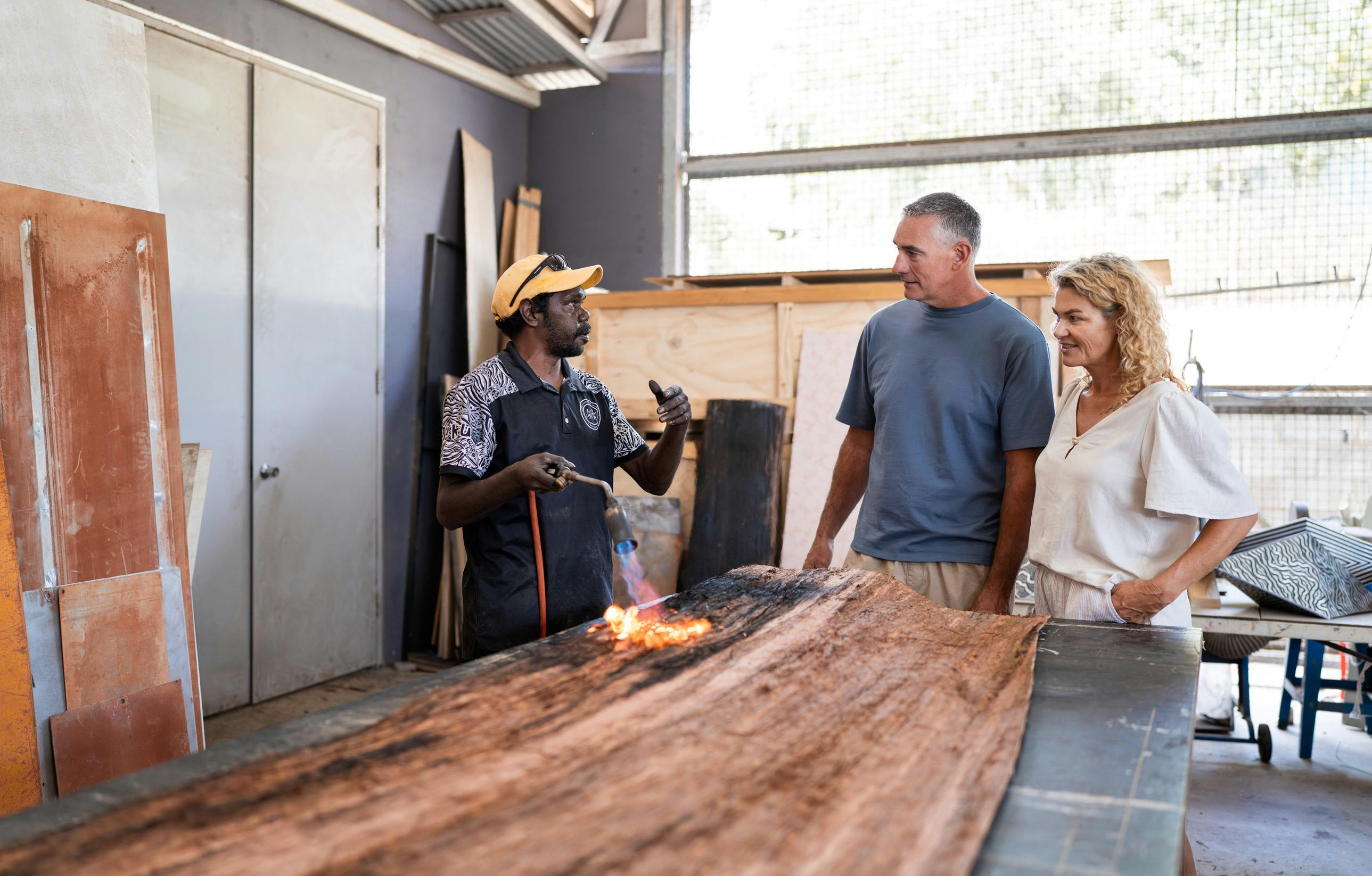 Buku Larrnggay Mulka art worker and visitors on guided art centre tour with The Yolngu Host