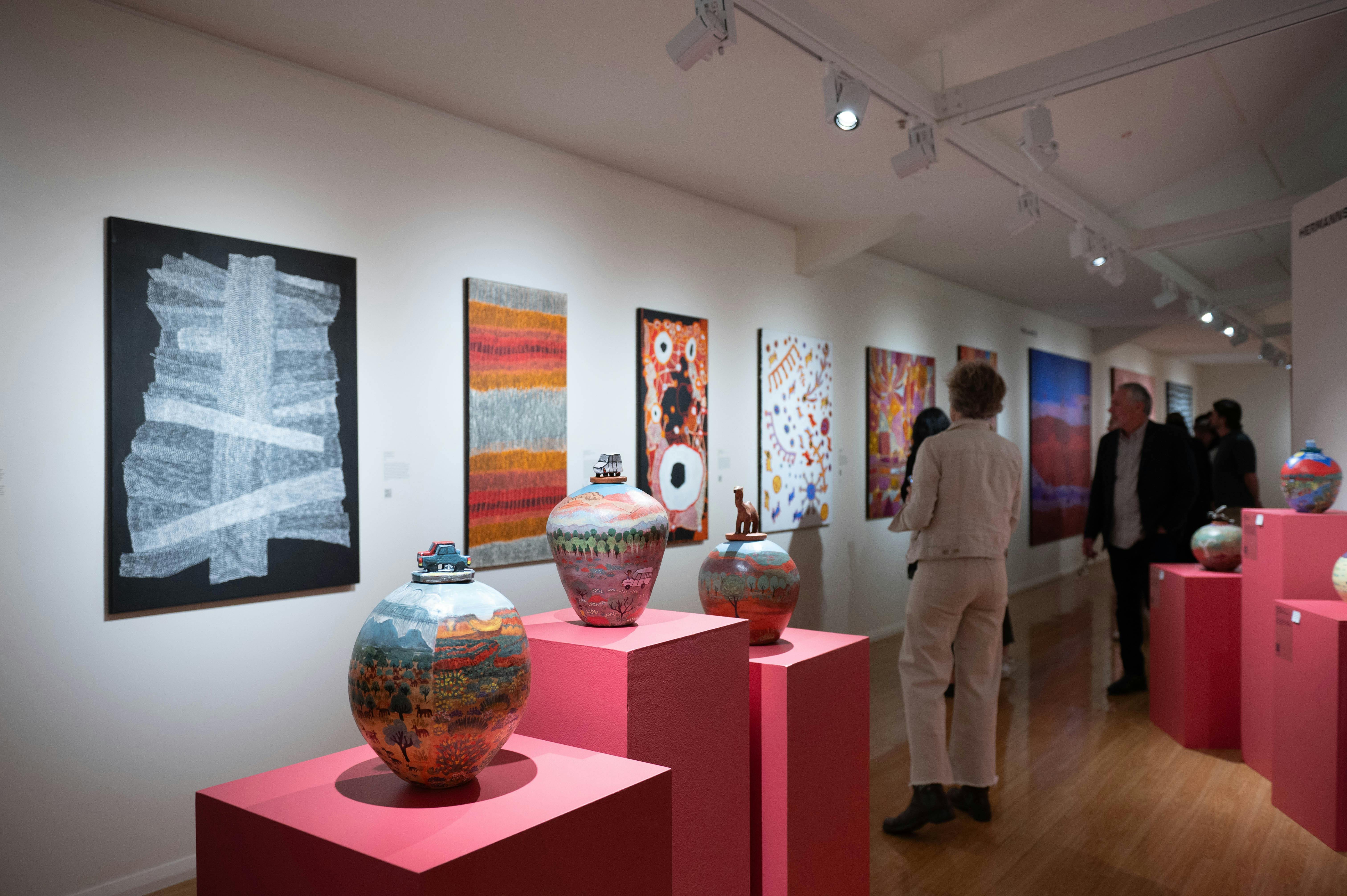 Desert Mob 2025 featuring works by Warlukurlangu Artists and Hermannsburg Potters.