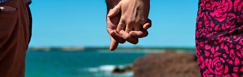 Couple at beach holding hands
