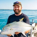 Giant trevally caught on Darwin Harbour, displaying its powerful build and silvery-grey scales.